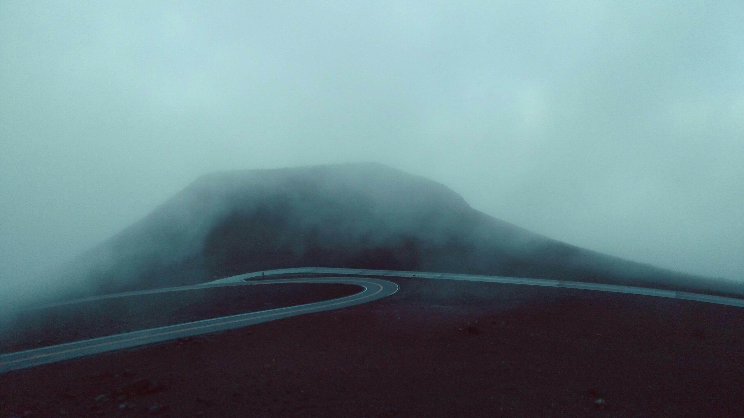 image of a winding road in the fog