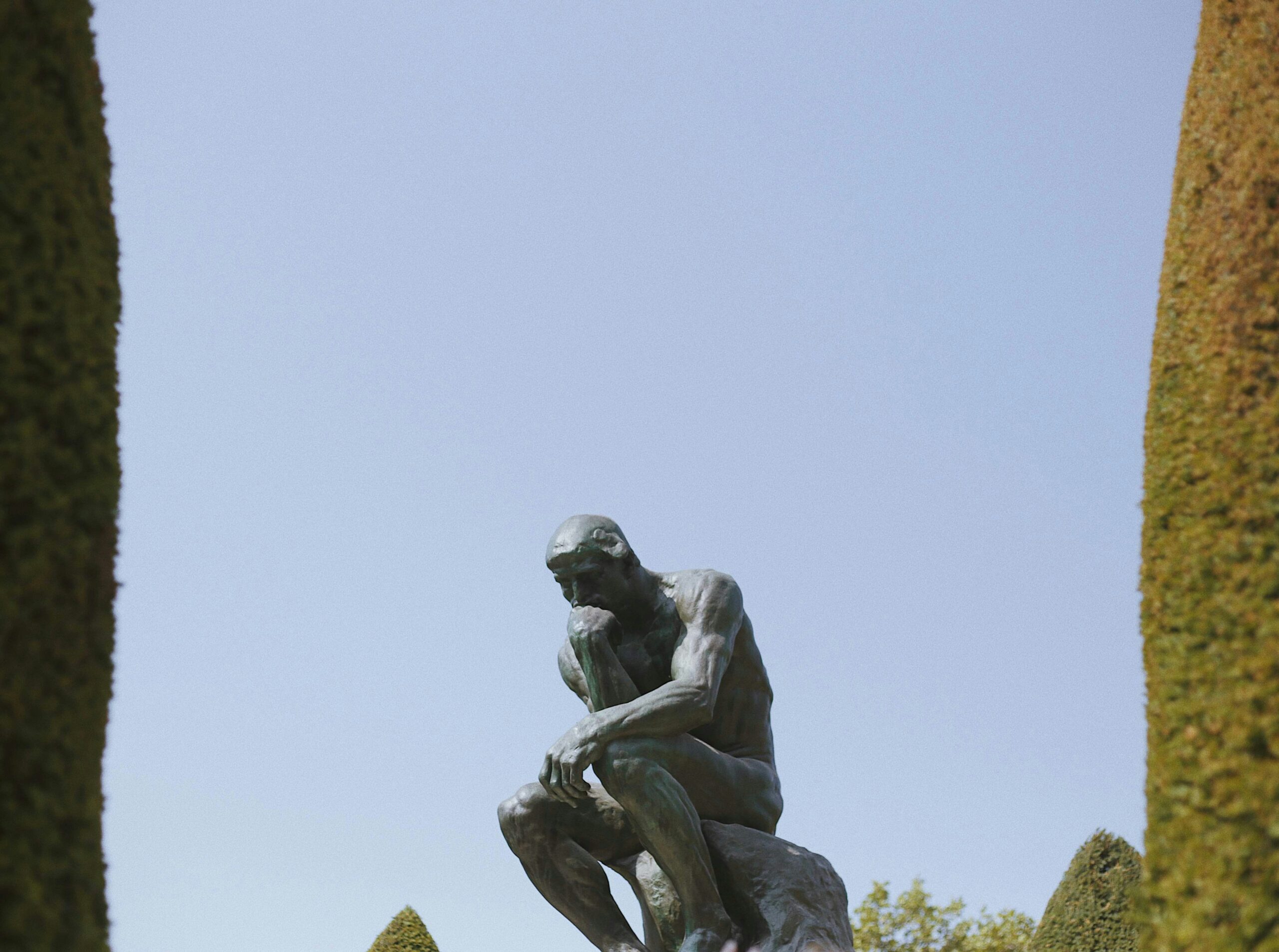 image of a man sitting on a rock and thinking